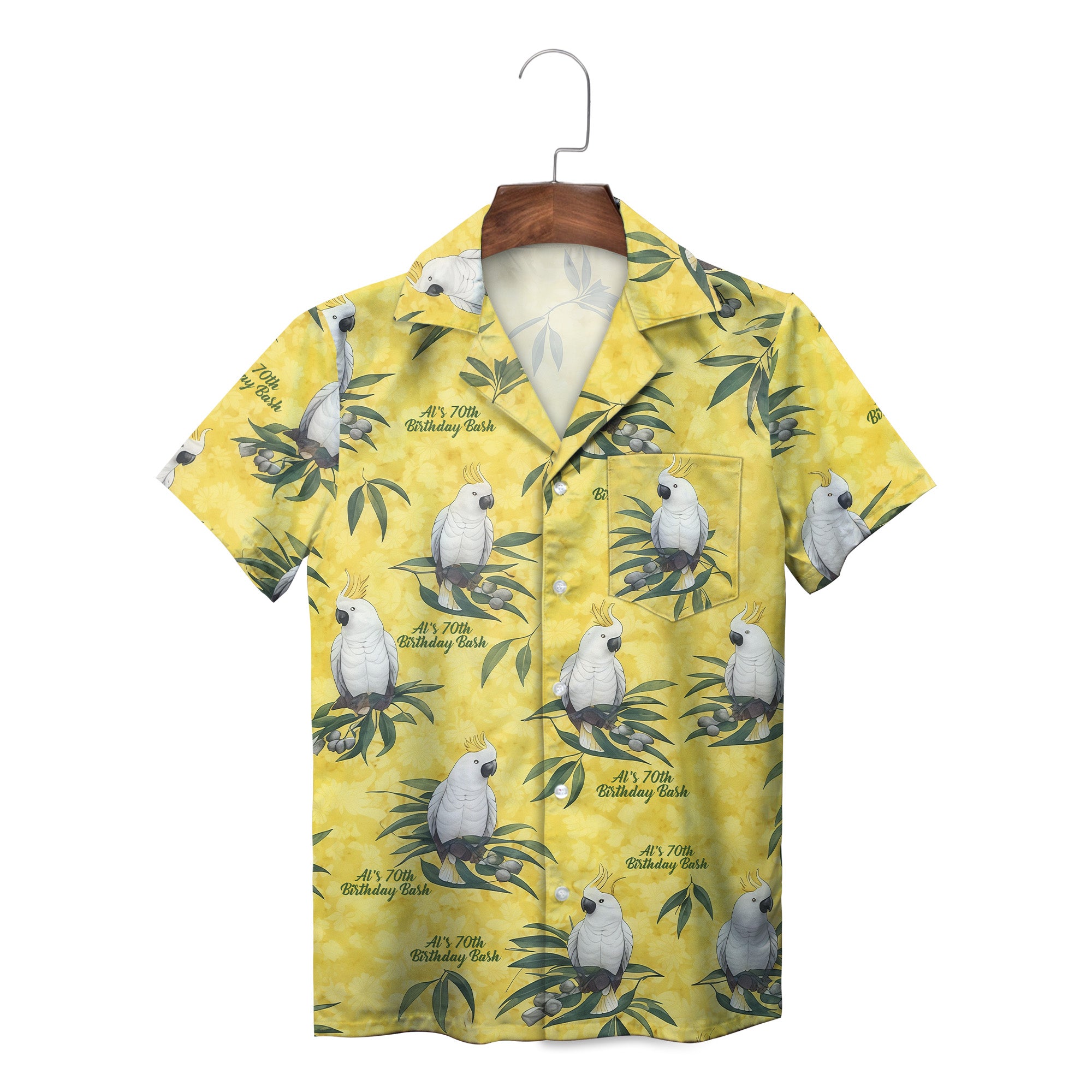 Yellow camp shirt featuring white crested parrots on green foliage