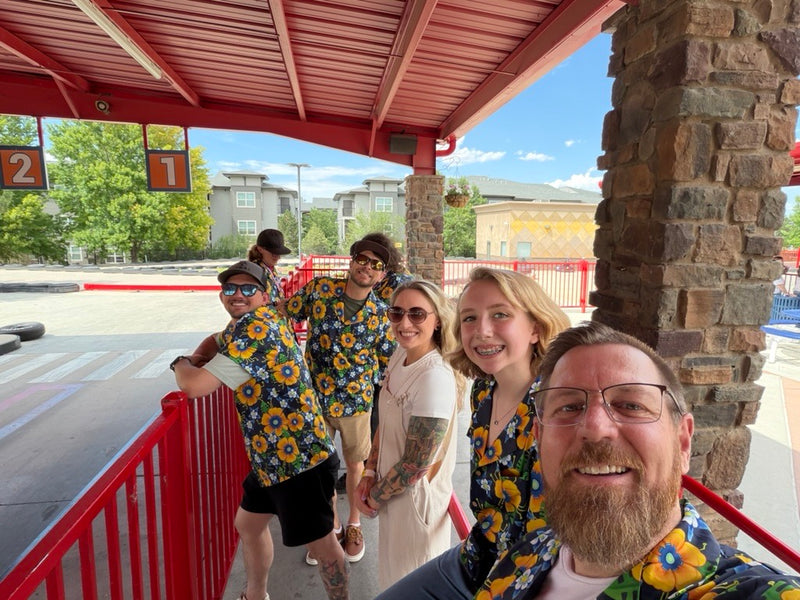 Universal Controls Solution team outing in custom navy floral Hawaiian shirts